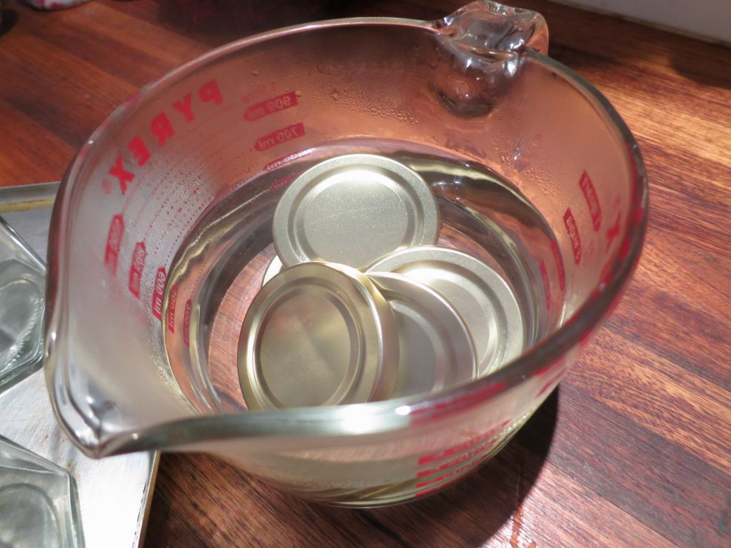 Method of sterilising jars, lids in boiling water.