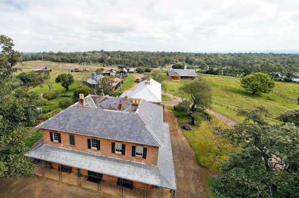 Aerial shot looking over the top of the house towards the stables and other outbuildings.