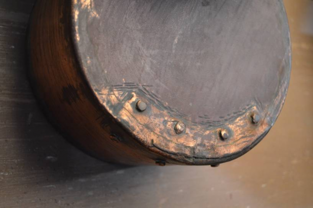 A pan showing evidence of repair on the bottom.