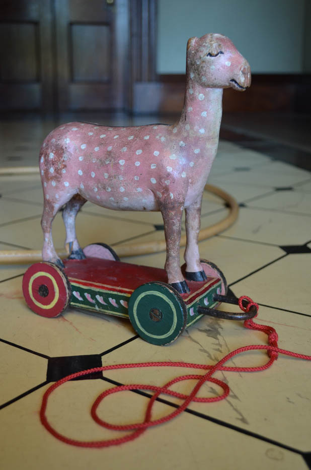 A reproduction spotted animal pull toy on the floor at Elizabeth Farm.