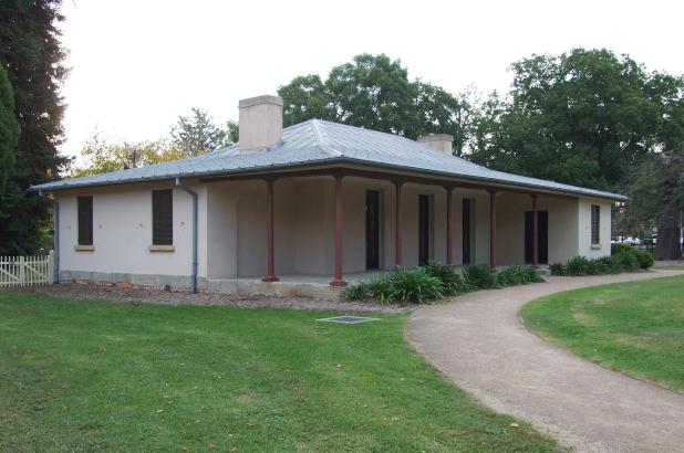 Exterior view, showing the lawns and verandah, of Hambledon Cottage, Parramatta.. 