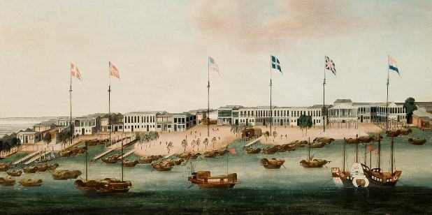 A harbour scene with various ships and flags.