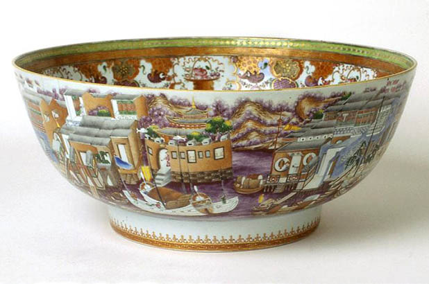 The bowl is painted with a continuous view of the Pearl River waterfront on Canton, depicting the thirteen hongs - wood and brick buildings that served foreign traders as residences, offices and warehouses.