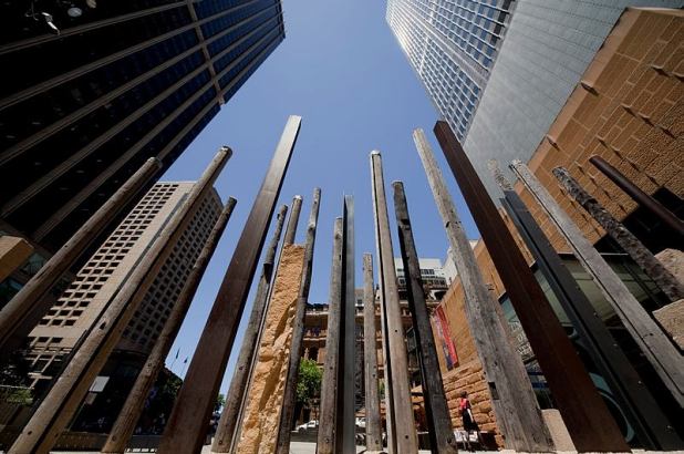 The forecourt at the Museum of Sydney, showing the artwork 'Edge of the Trees' by Janet Laurence, surrounded by the Sydney City CBD