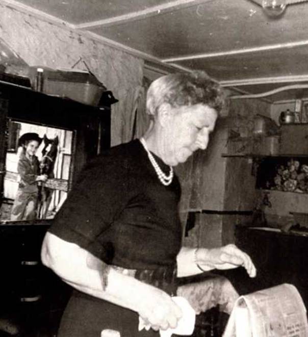 Mary 'Girlie' Andersen in the basement kitchen, the sink can be seen to the right.