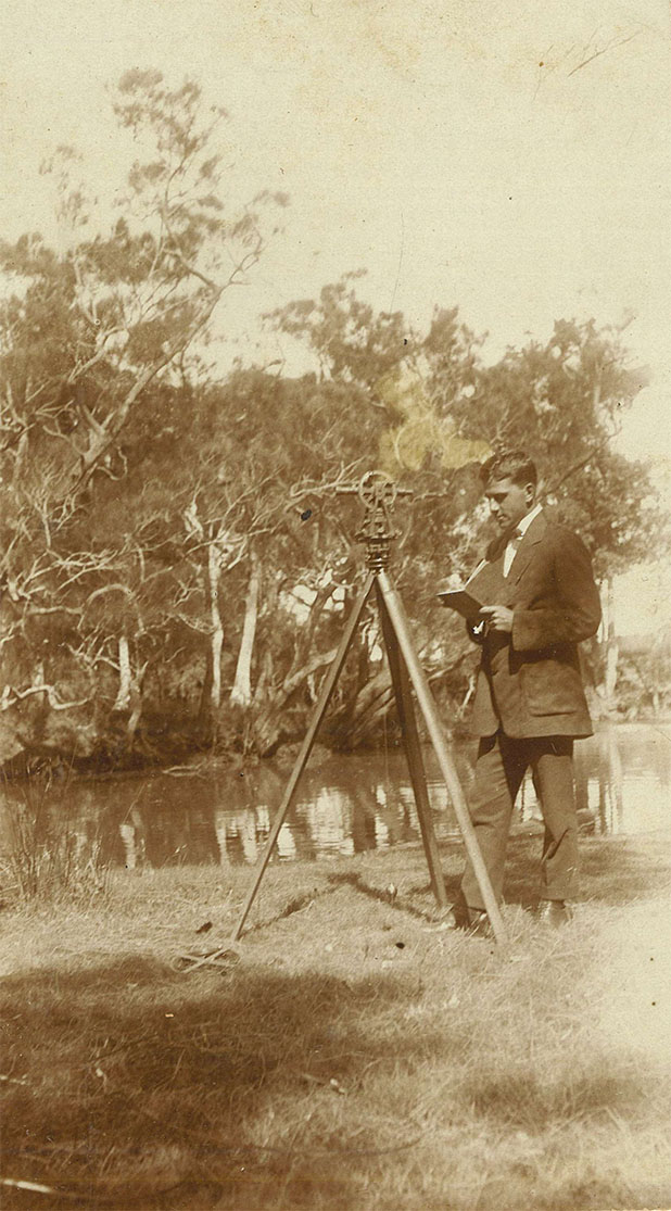 Robert Barnet standing next to a tripod in a bush setting.