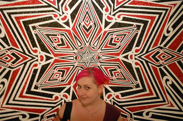 Bethany Leyshon in front of an artwork, A Crucifixion, at the National Gallery of Victoria.