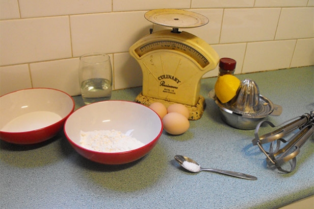 Ingredients for spun sugar cake icluding flour, eggs, sugar, lemon and cinnamon.