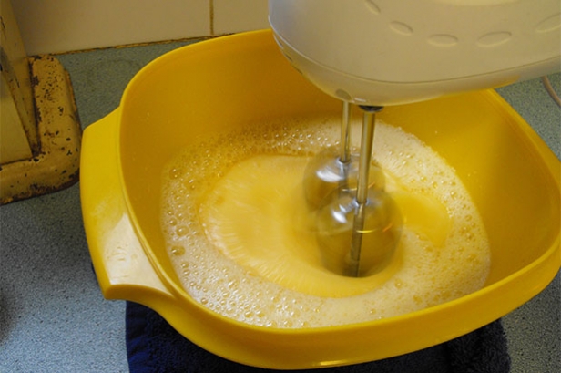 Mixing the spun sugar cake batter with an electric mixer