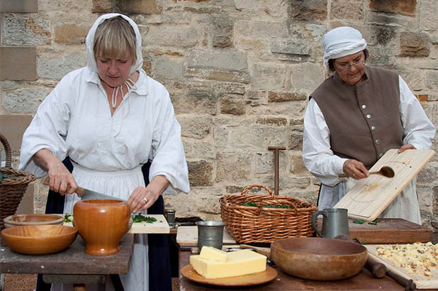 Two women cooking at 'Redcoats and Convicts' at Hyde Park Barracks.