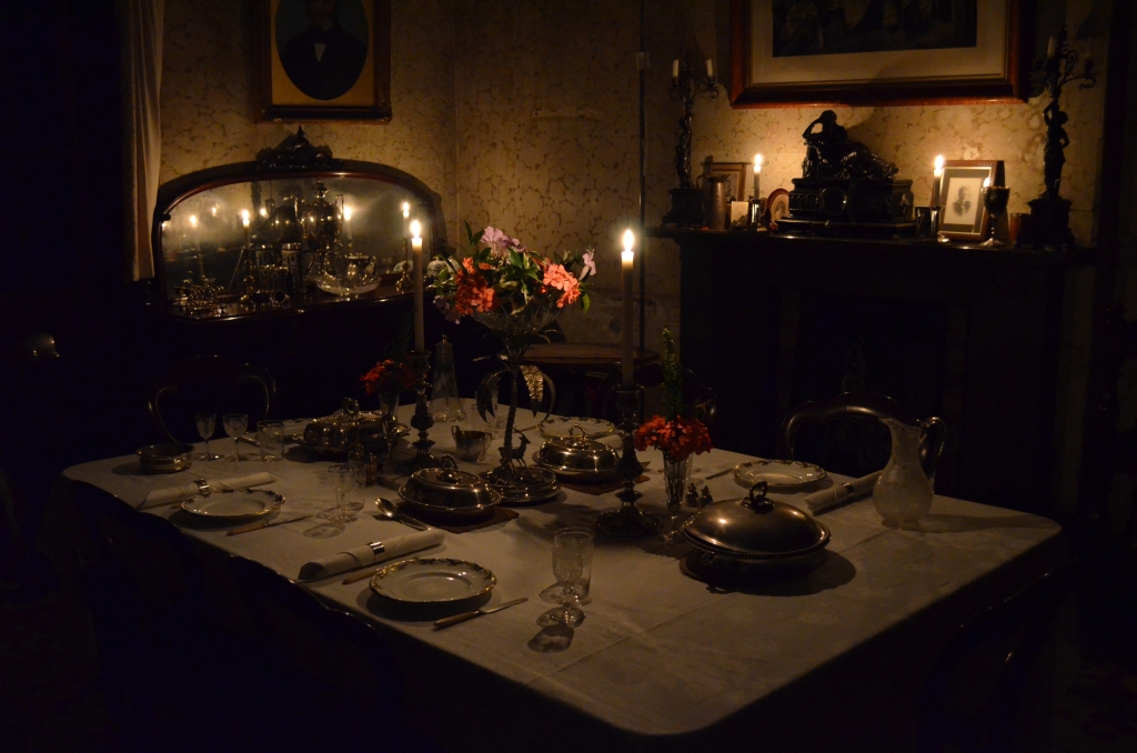 The dining room at Rouse Hill House lit by candles